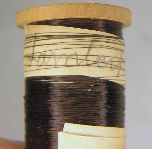 The paper wrapping of a Bulle coil bobbin with a handwritten signature
